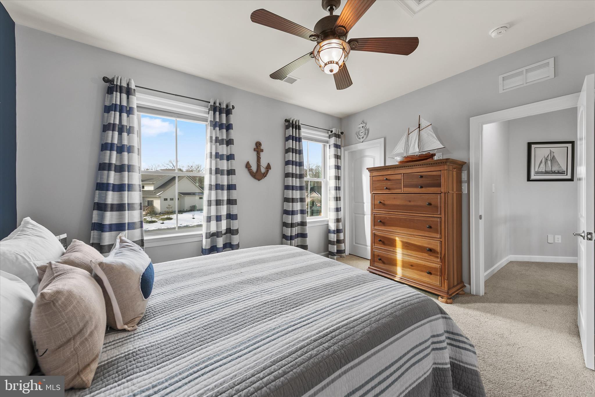 34749 Timber Court Dagsboro, DE 19939 - Photo 36 of 60 a bedroom with a large bed and a chandelier