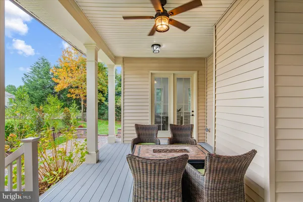 a front view of a house with a yard and potted plants