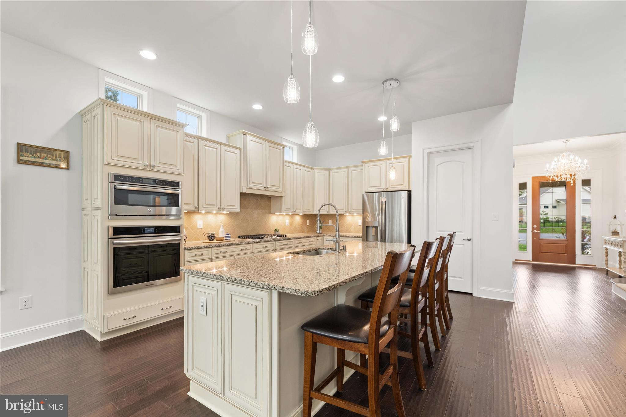 34749 Timber Court Dagsboro, DE 19939 - Photo 8 of 60 a kitchen with kitchen island a stove a table and chairs in it