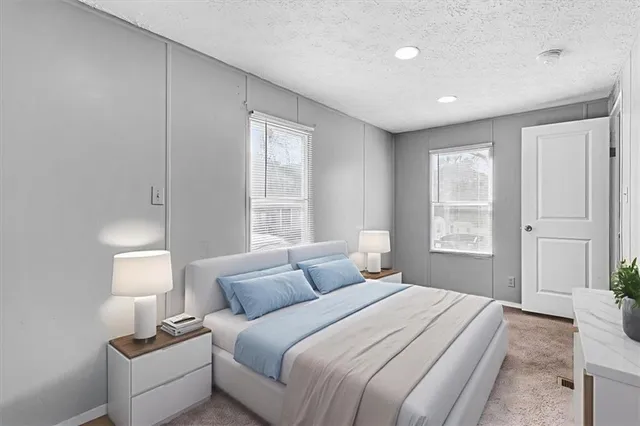 a bedroom with a bed and a night stand