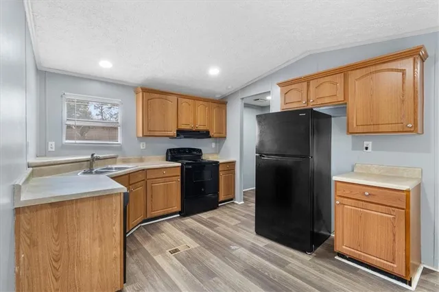 a kitchen with a refrigerator stove and sink