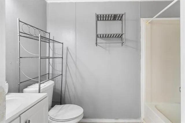 a white toilet sitting next to a bathroom sink