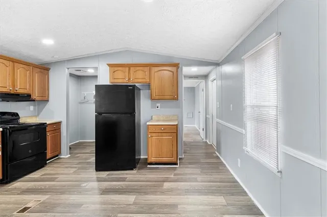a kitchen with a refrigerator cabinet and a sink