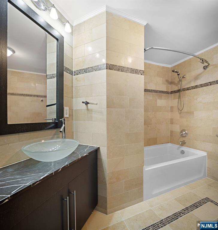 1286 River Road Edgewater, NJ 07020 - Photo 15 of 19 a bathroom with a granite countertop sink mirror bathtub and shower