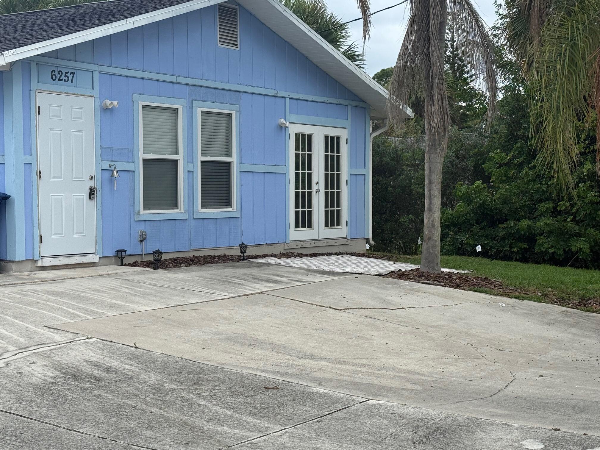 6257 Kendrick Street, Unit 2 Jupiter, FL 33458 - Photo 11 of 11 a front view of a house with a garden