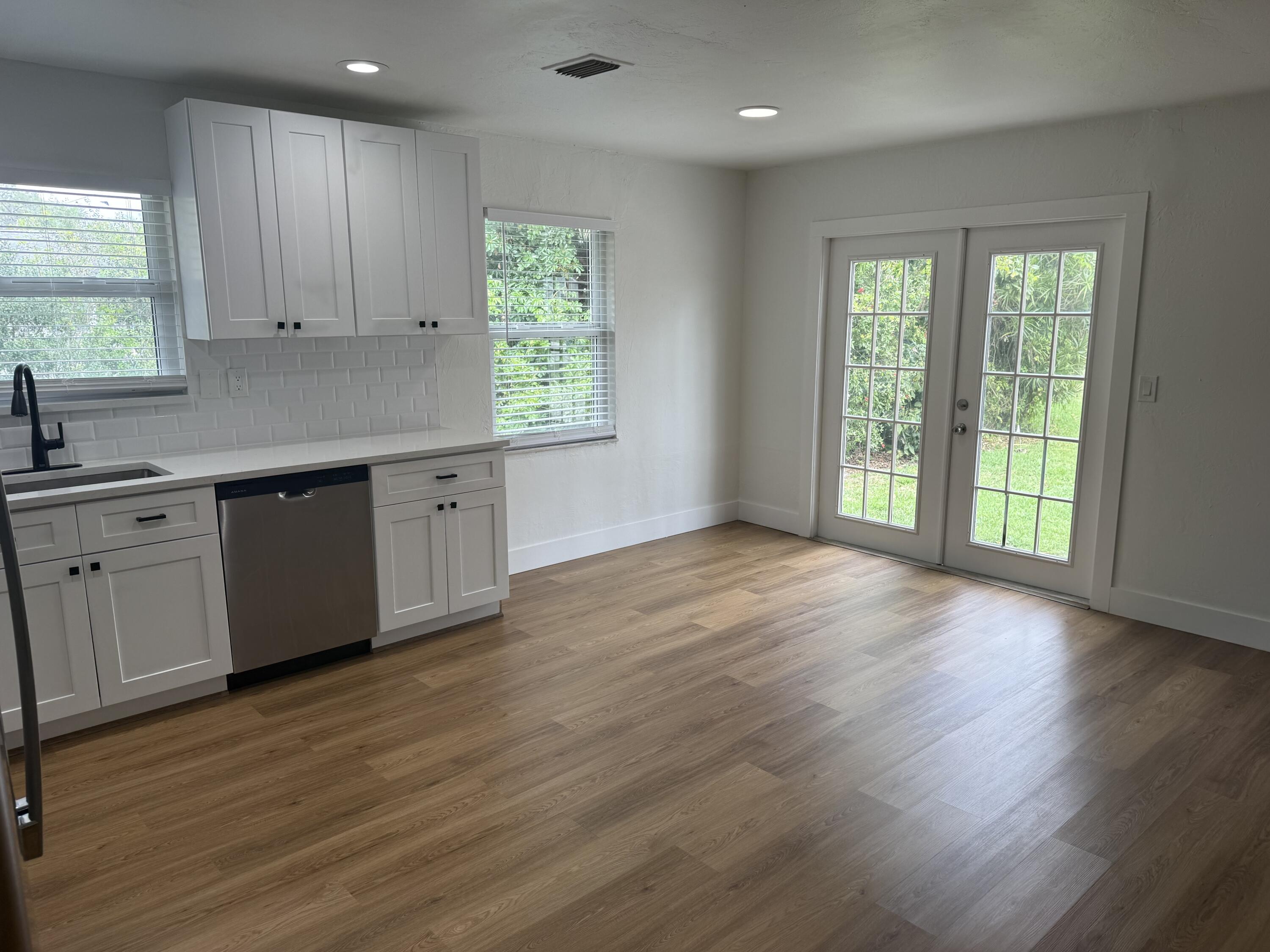 6257 Kendrick Street, Unit 2 Jupiter, FL 33458 - Photo 3 of 11 a view of a kitchen with wooden floor and a sink
