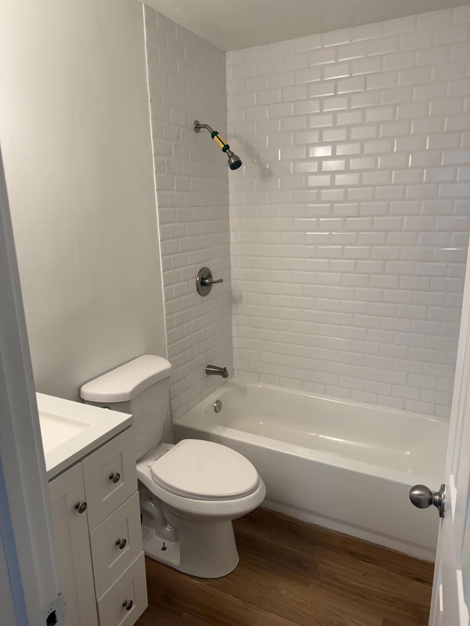 6257 Kendrick Street, Unit 2 Jupiter, FL 33458 - Photo 4 of 11 a bathroom with a toilet and a shower