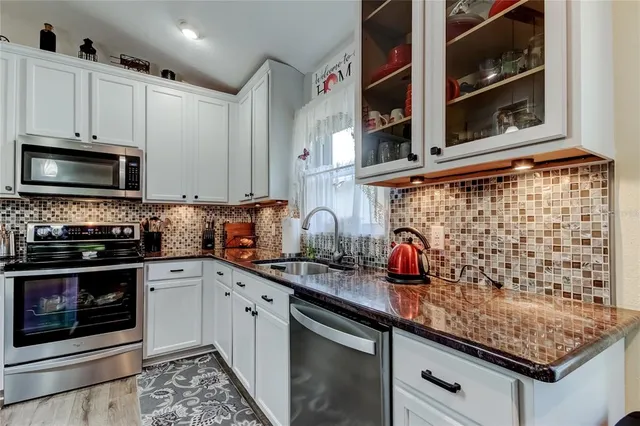 a living room with furniture a large window and a flat screen tv