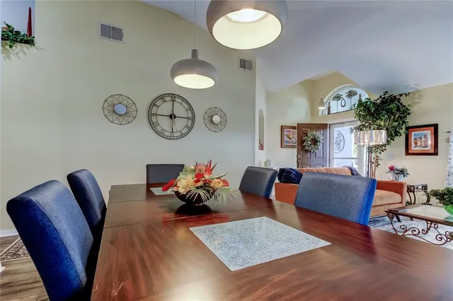 a bedroom with a bed and a lamp on dresser