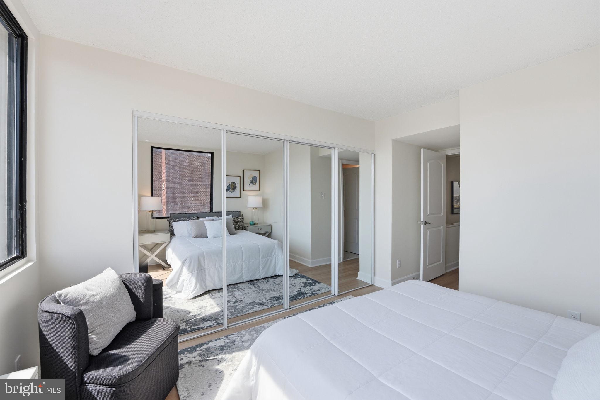 1245 13th Street Northwest, Unit 901 Washington, DC 20005 - Photo 29 of 38 a bedroom with a bed and a chair