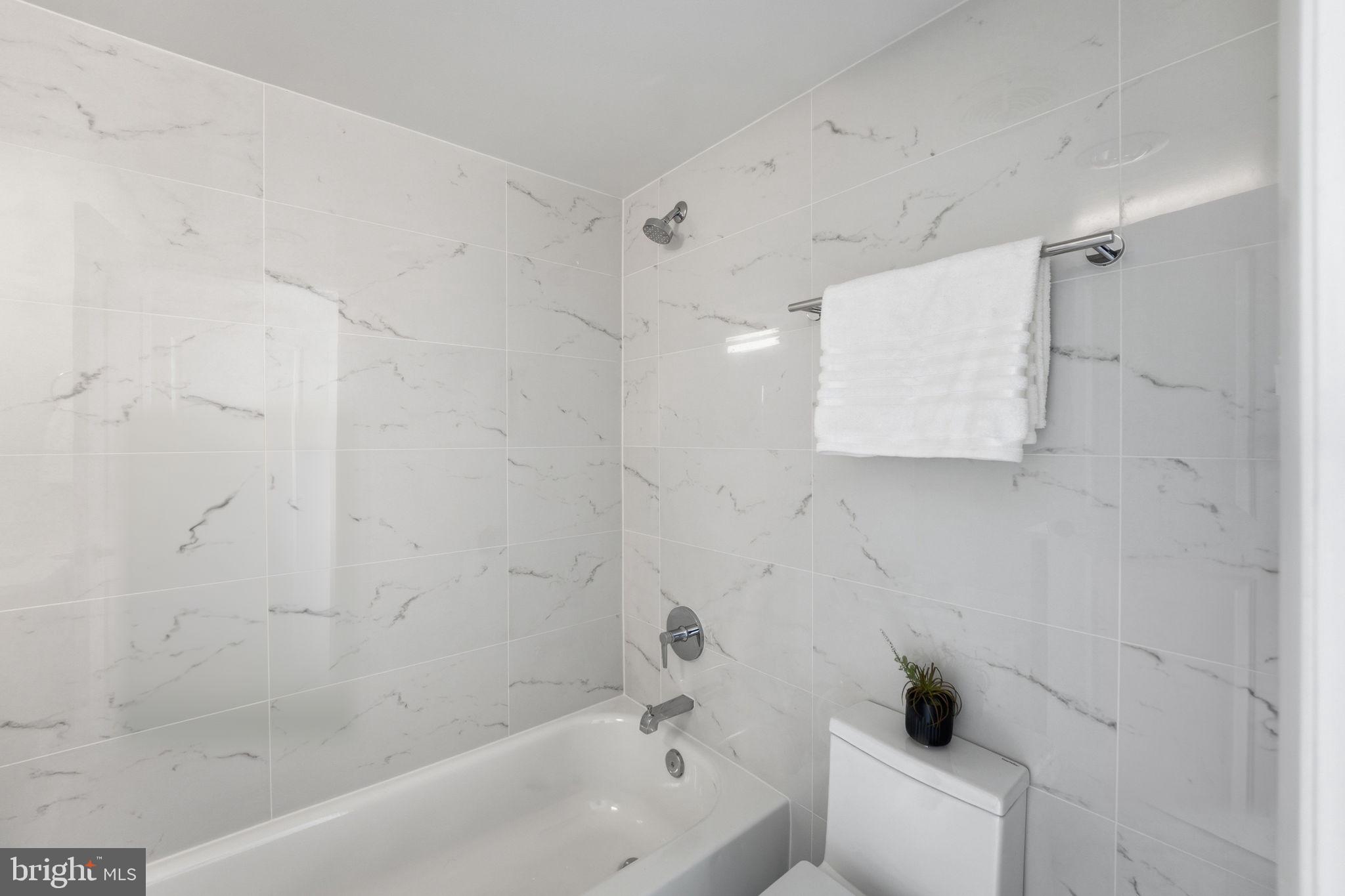 1245 13th Street Northwest, Unit 901 Washington, DC 20005 - Photo 31 of 38 a bathroom with a bathtub and shower