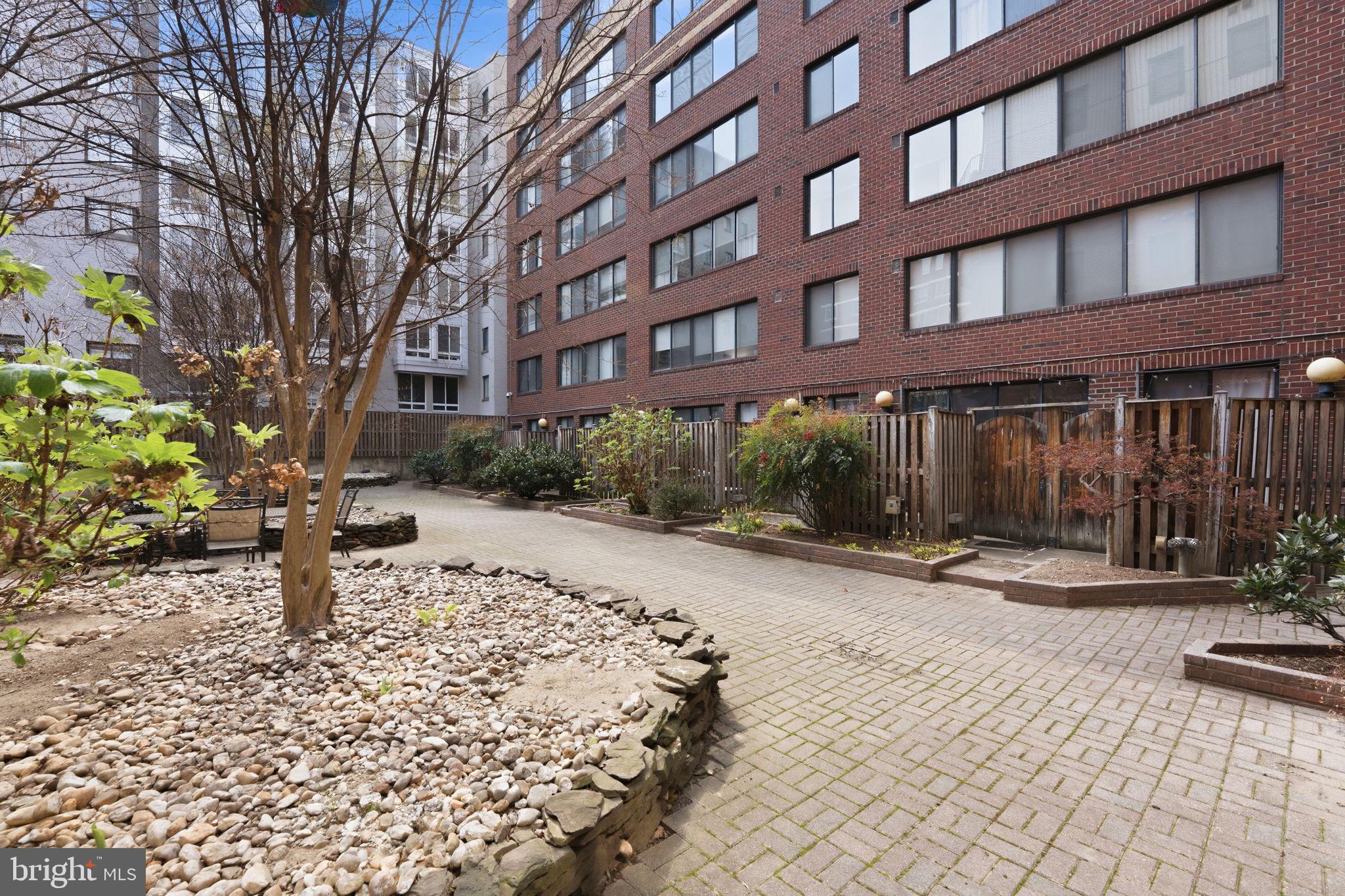 1245 13th Street Northwest, Unit 901 Washington, DC 20005 - Photo 36 of 38 a pathway of a building with a yard