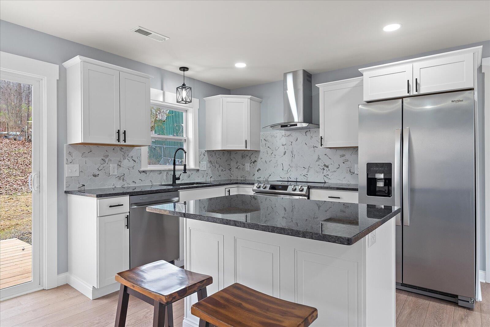 1917 Cir Drive Southwest Cleveland, TN 37311 - Photo 9 of 25 a kitchen with stainless steel appliances granite countertop a sink refrigerator and cabinets