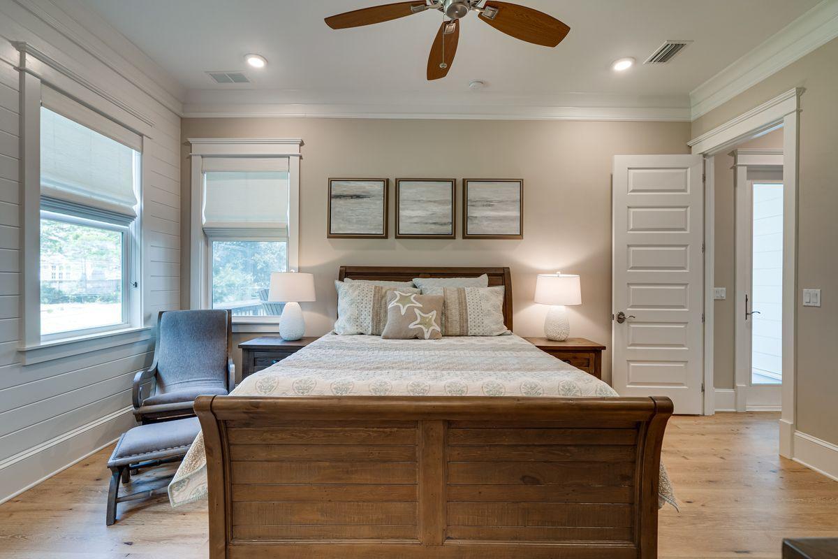 36 Clipper Street Inlet Beach, FL 32461 - Photo 16 of 44 a bedroom with a bed and wooden floor