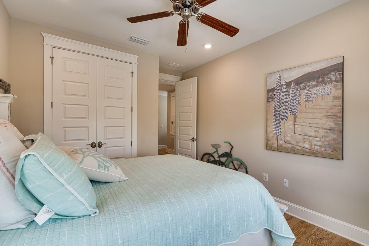 36 Clipper Street Inlet Beach, FL 32461 - Photo 26 of 44 a bedroom with a bed ceiling fan and a wooden floor