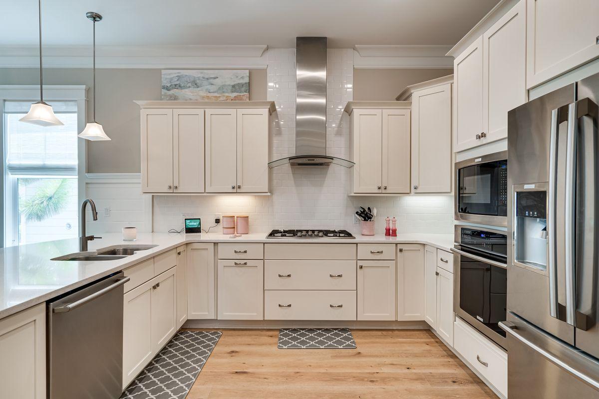 36 Clipper Street Inlet Beach, FL 32461 - Photo 7 of 44 a kitchen with stainless steel appliances and white cabinets