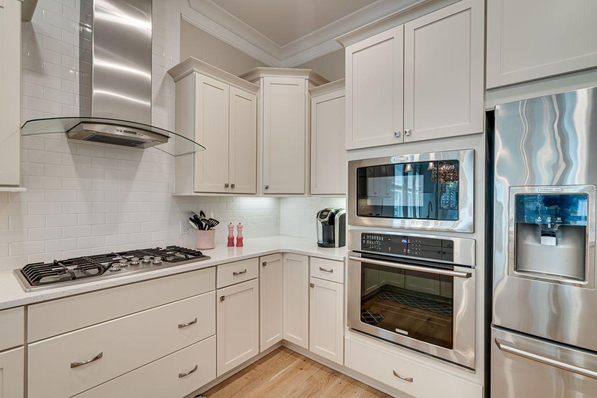 36 Clipper Street Inlet Beach, FL 32461 - Photo 8 of 44 a kitchen with white cabinets and stainless steel appliances