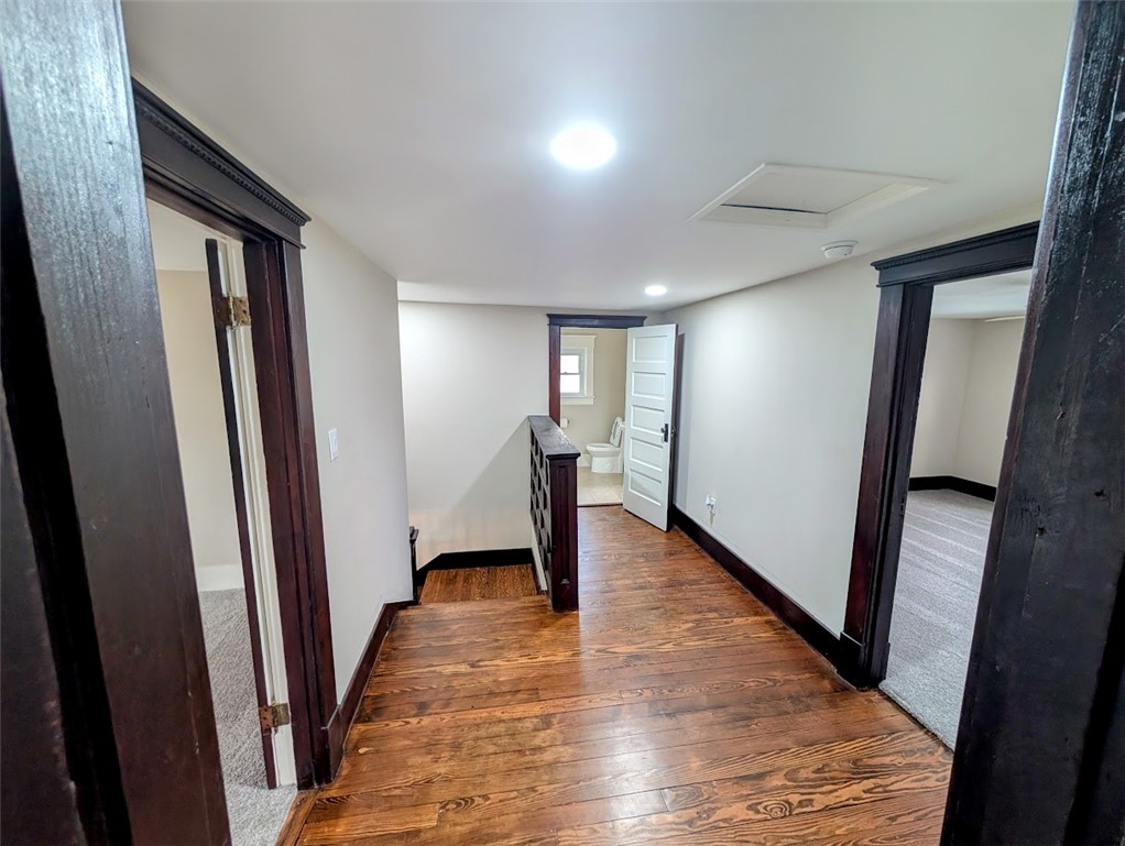 10796 Preble County Line Road Brookville, OH 45309 - Photo 17 of 33 This spacious hallway features rich hardwood flooring, leading to inviting rooms and a well-appointed bathroom.