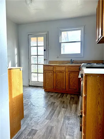 a kitchen with a stove a sink and a window
