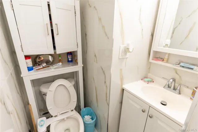 a bathroom with a sink a toilet and a mirror