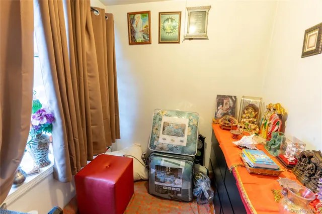 a living room with furniture a air conditioner and a window
