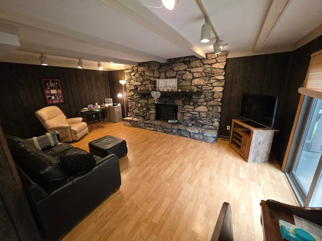 a view of game room with window and wooden floor