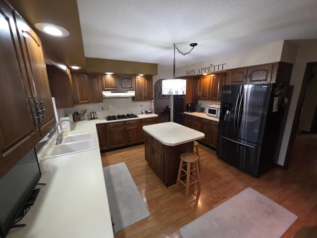 a kitchen with stainless steel appliances a refrigerator and a sink