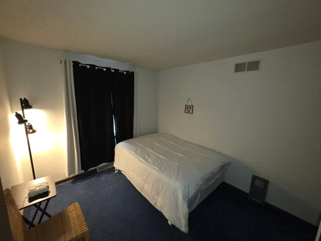 a bedroom with a bed and dresser