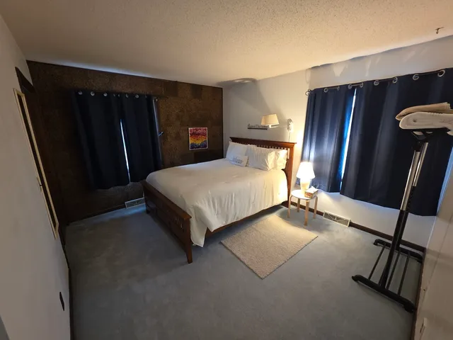 a bedroom with furniture and a window