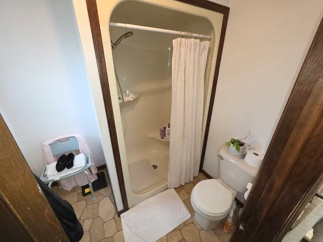 a bedroom with a bed and a tv on table