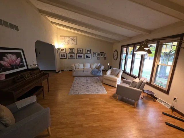 a living room with furniture and a large window