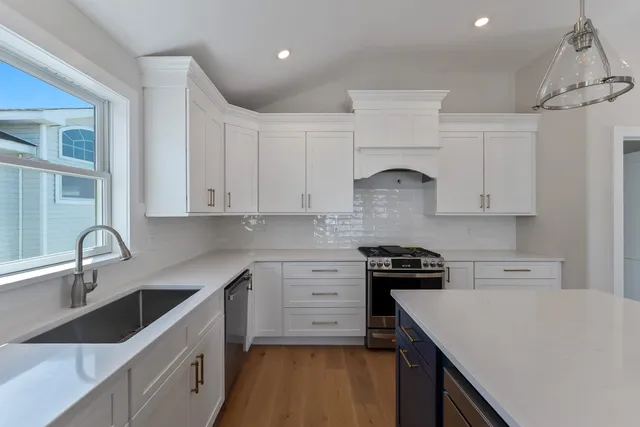 a kitchen with white cabinets and appliances
