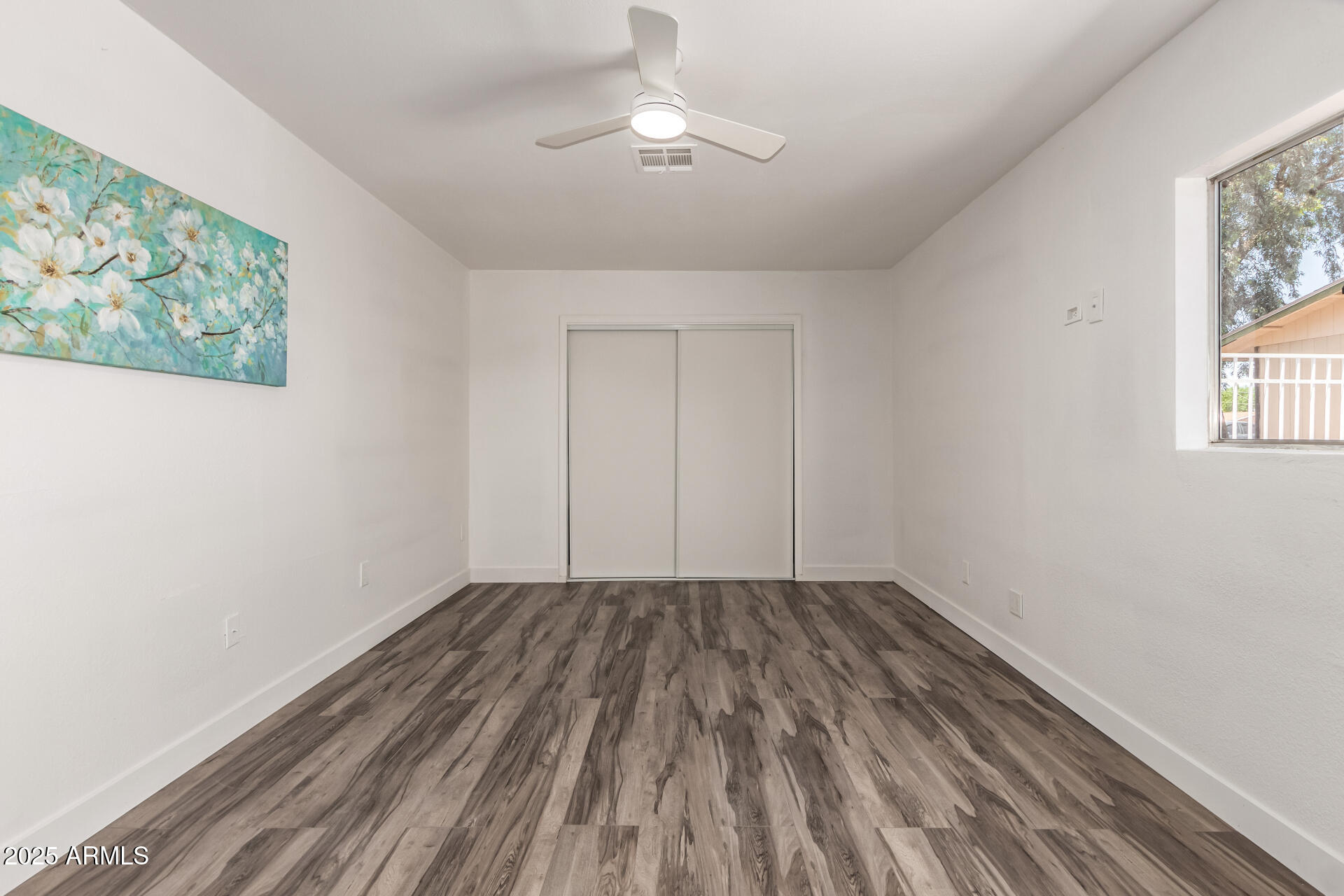 39 North Maple Mesa, AZ 85205 - Photo 12 of 29 a view of room with window ceiling fan and wooden floor