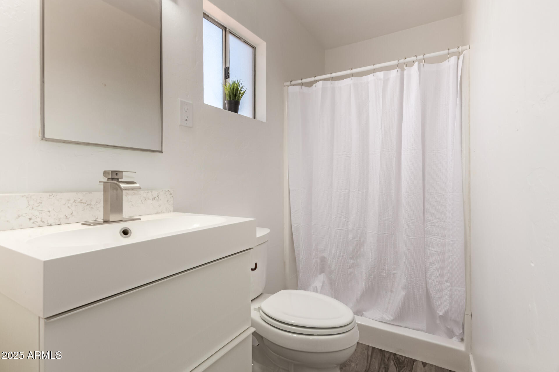 39 North Maple Mesa, AZ 85205 - Photo 14 of 29 a bathroom with a sink a toilet and a mirror