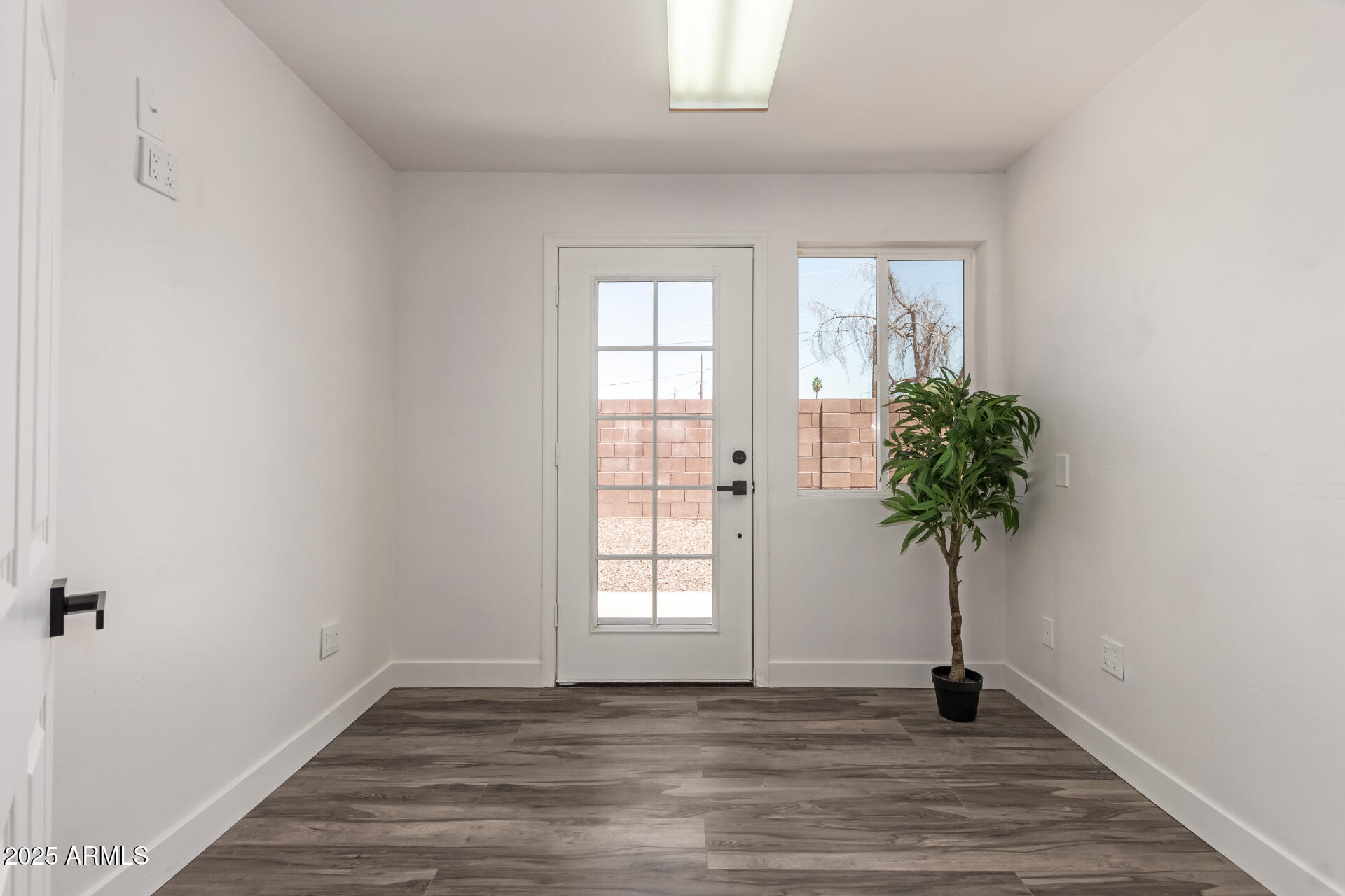 39 North Maple Mesa, AZ 85205 - Photo 17 of 29 a view of an empty room with a window and wooden floor