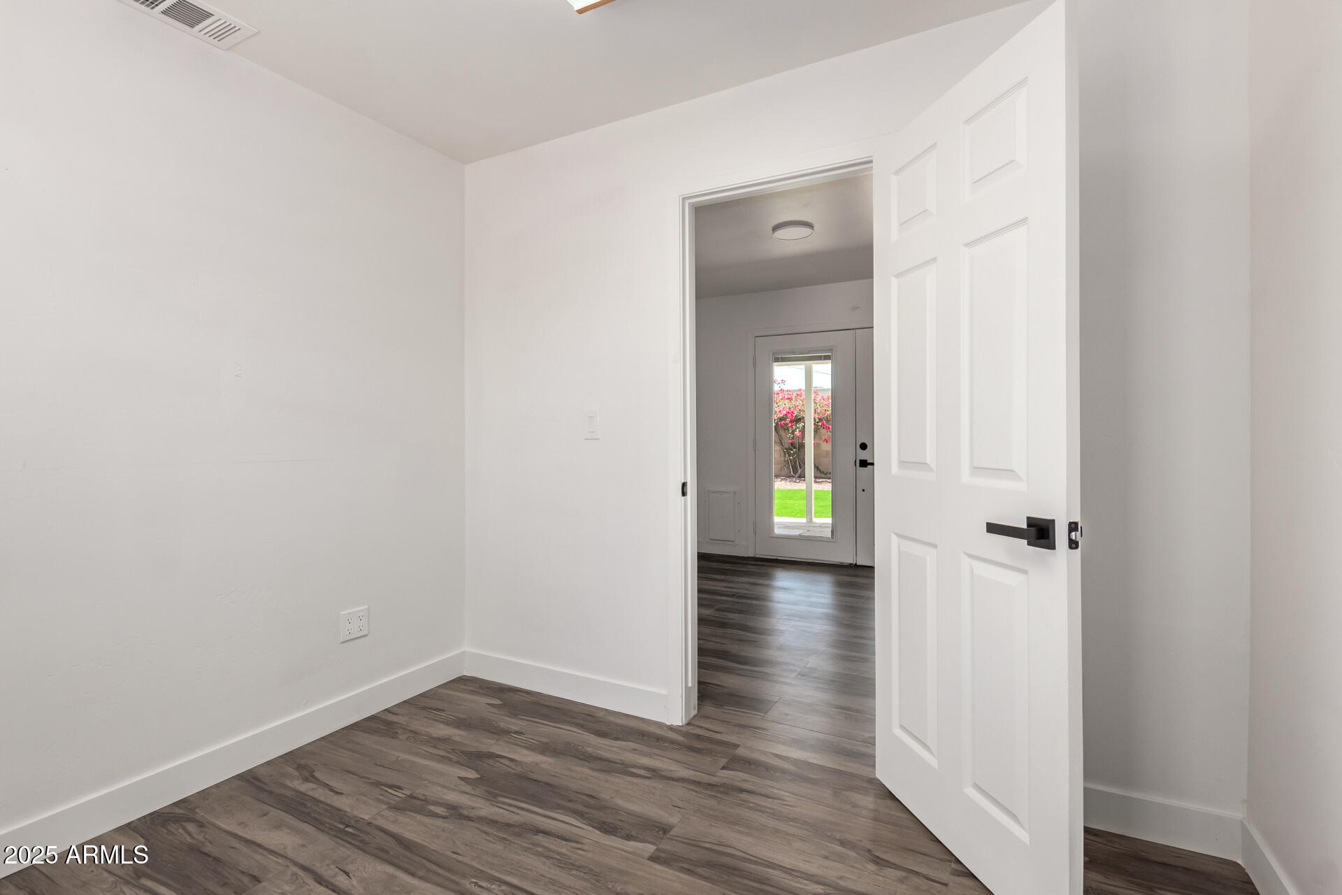 39 North Maple Mesa, AZ 85205 - Photo 18 of 29 a view of an empty room with wooden floor and a bathroom