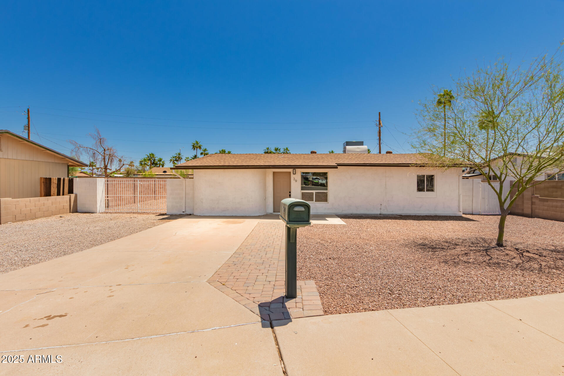 39 North Maple Mesa, AZ 85205 - Photo 6 of 29 a view of a house with a yard and garage