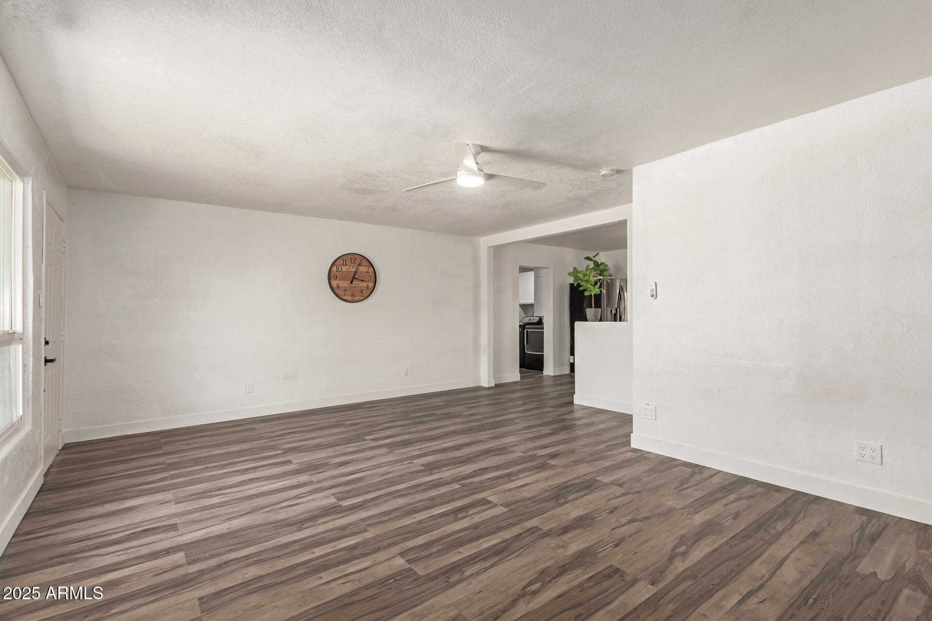 39 North Maple Mesa, AZ 85205 - Photo 9 of 29 a view of an empty room with wooden floor and a window