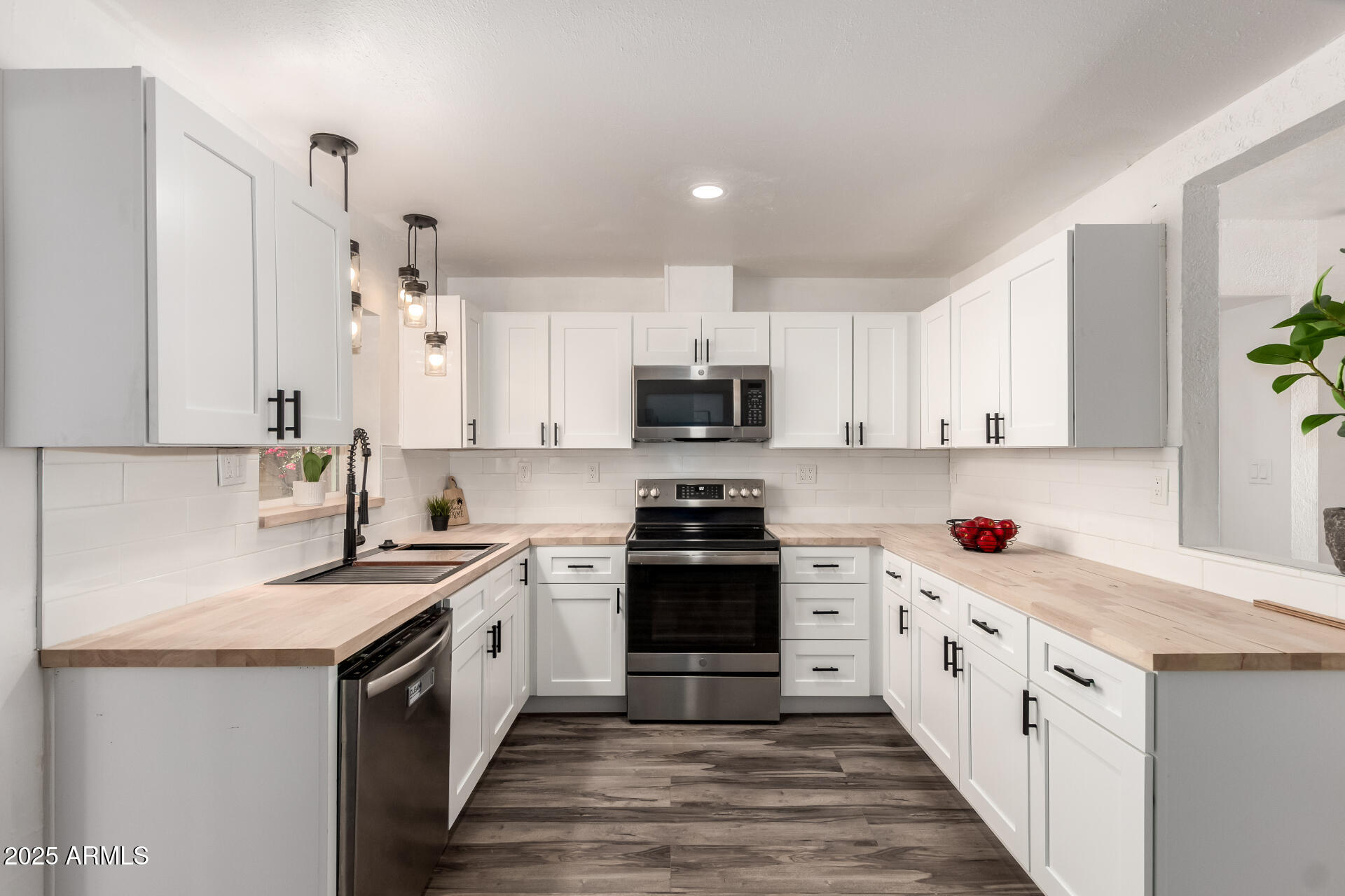 39 North Maple Mesa, AZ 85205 - Photo 10 of 29 a kitchen with stainless steel appliances granite countertop a sink and a stove