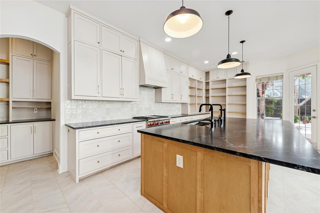 2107 Spindletop Trail Frisco, TX 75033 - Photo 14 of 39 a kitchen with stainless steel appliances granite countertop a sink a stove and a refrigerator