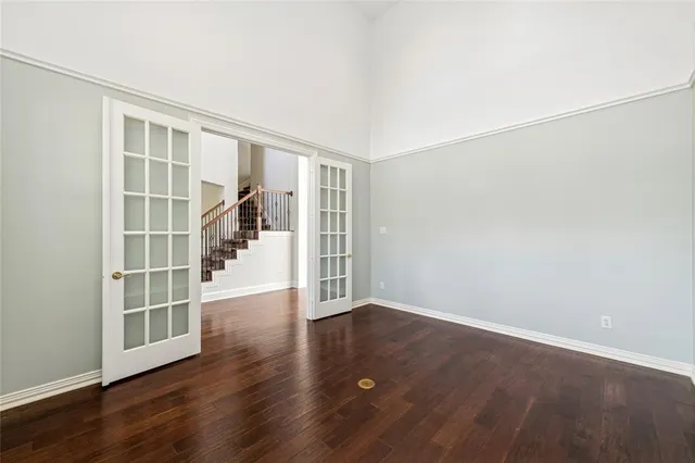 a view of a livingroom with a fireplace a ceiling fan and wooden floor