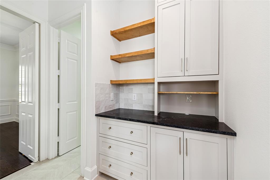 2107 Spindletop Trail Frisco, TX 75033 - Photo 16 of 39 a kitchen with white cabinets and a sink