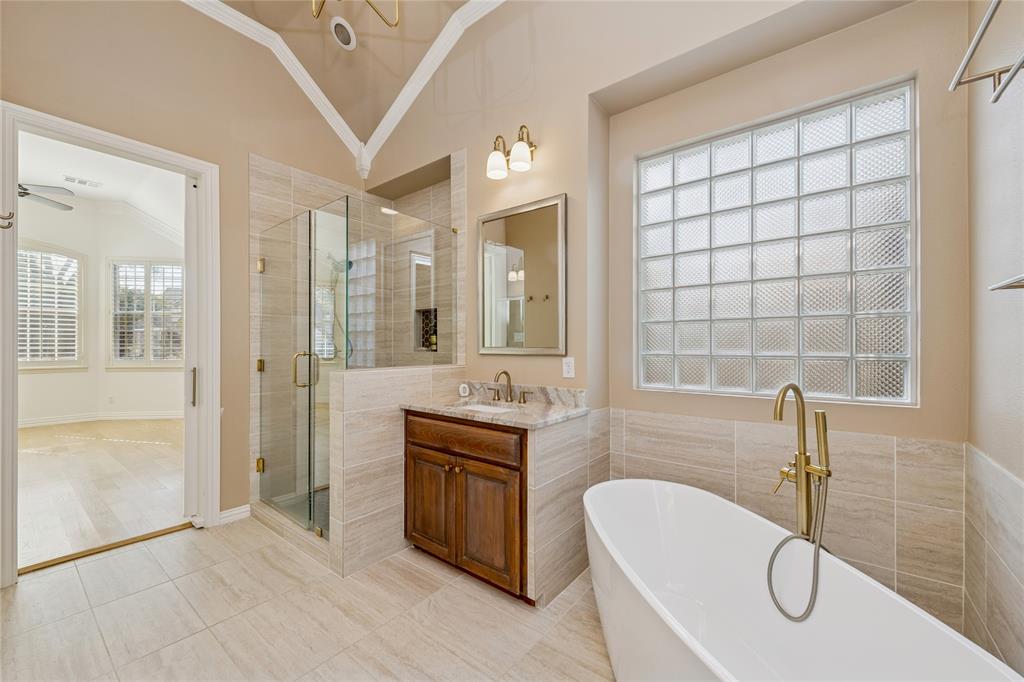 2107 Spindletop Trail Frisco, TX 75033 - Photo 21 of 39 a spacious bathroom with a granite countertop tub sink and mirror