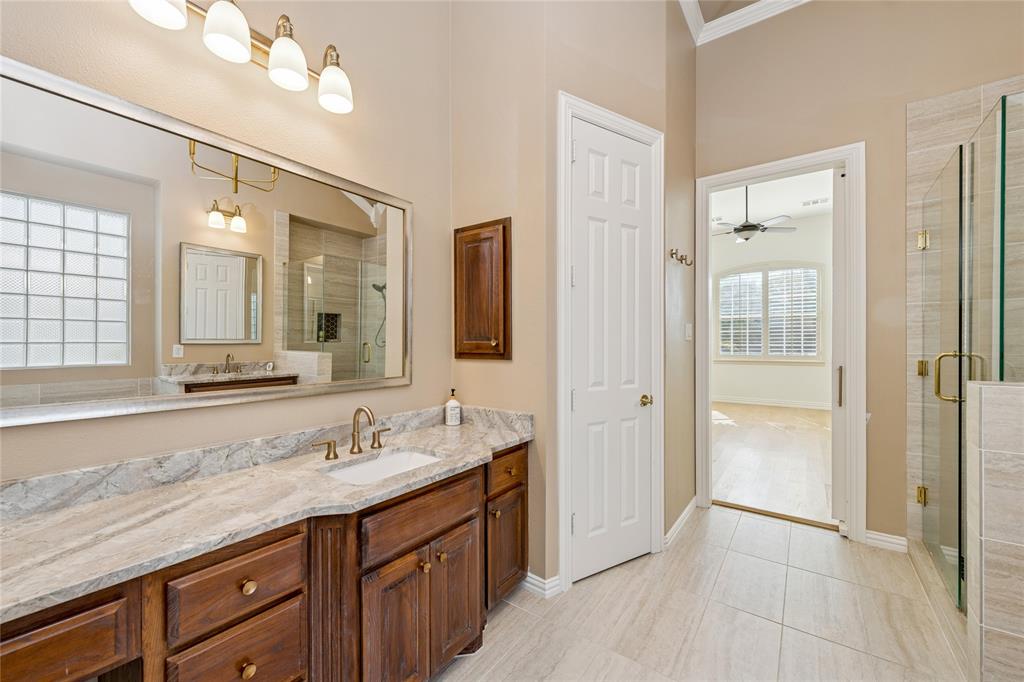 2107 Spindletop Trail Frisco, TX 75033 - Photo 22 of 39 a spacious bathroom with a granite countertop sink a mirror and a shower