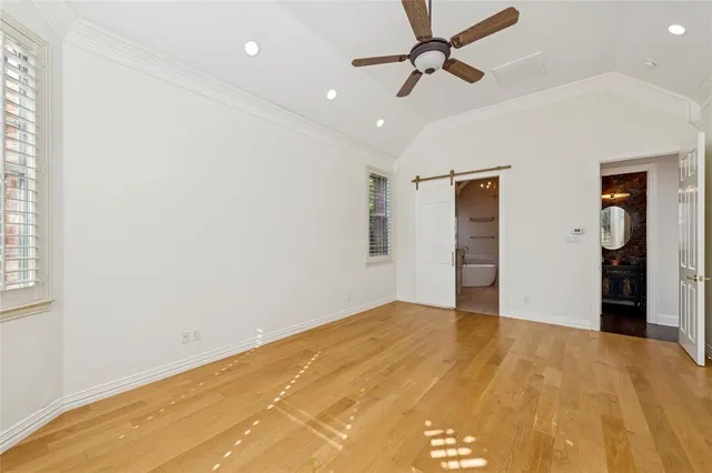 an empty room with wooden floor and closet