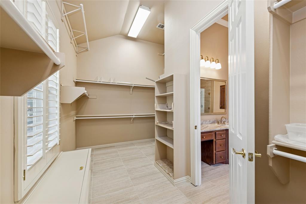 2107 Spindletop Trail Frisco, TX 75033 - Photo 23 of 39 a view of walk in closet with empty racks