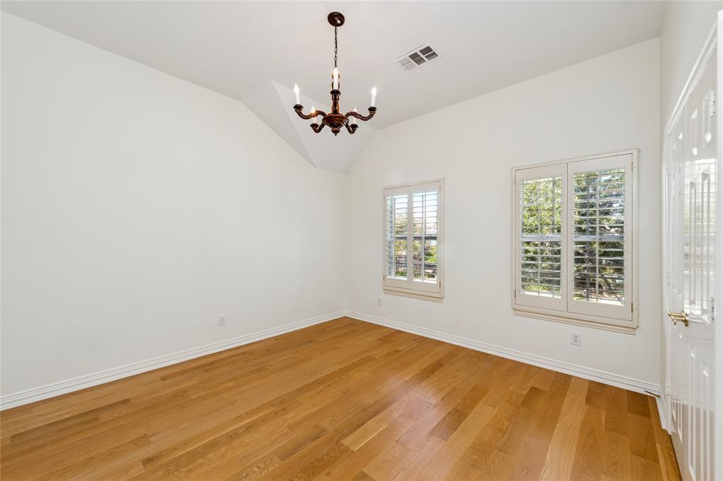 2107 Spindletop Trail Frisco, TX 75033 - Photo 32 of 39 an empty room with a chandelier fan and windows