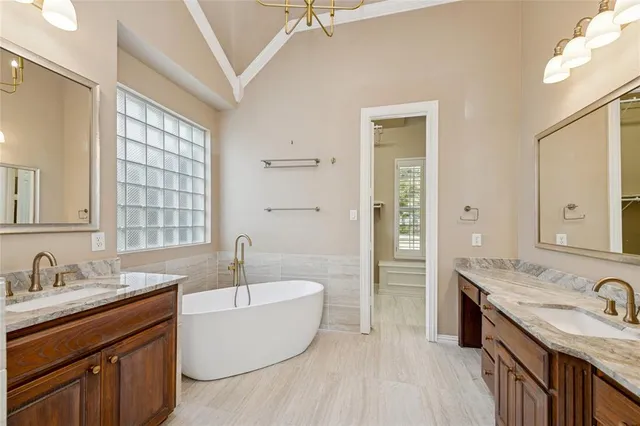 a bathroom with a granite countertop tub sink double vanity granite tub and shower