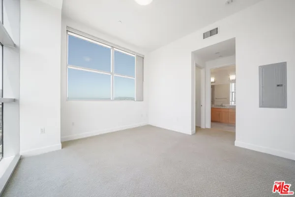 an empty room with a empty space and windows