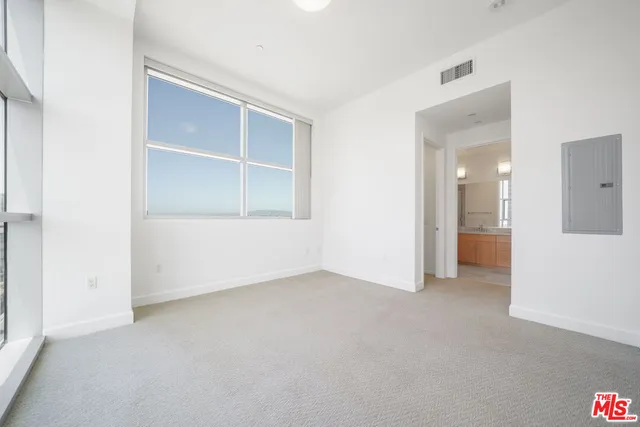 an empty room with a empty space and windows